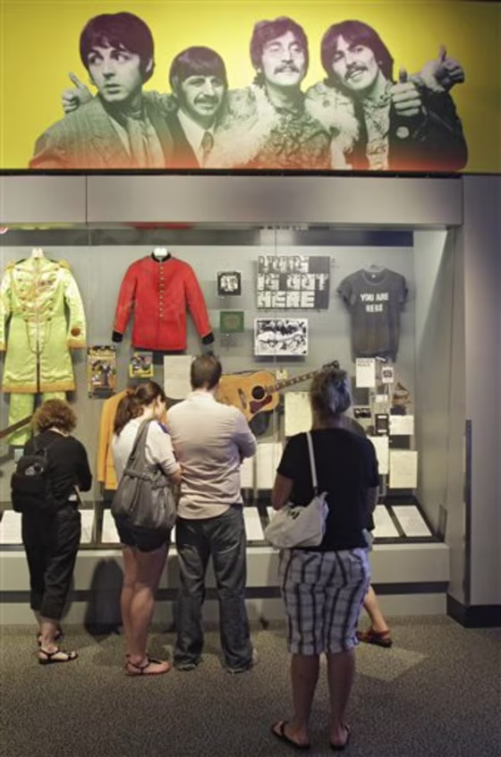 Visitors view an exhibit on The Beatles, at the Rock and Roll Hall of Fame and Museum in Cleveland. The Rock Hall says the exhibit is the world's largest collection of items from the group, as part of a redesign.